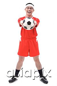 AsiaPix - Man in soccer uniform holding soccer ball towards camera