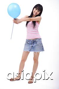 AsiaPix - Young woman holding a blue balloon