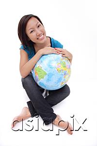 AsiaPix - Woman holding globe, sitting cross-legged
