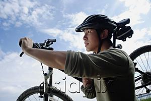 AsiaPix - Man carrying bicycle