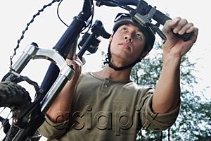 AsiaPix - Man carrying bicycle, low angle view