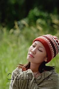 AsiaPix - Woman with ski cap, wrapped in a blanket, eyes closed