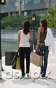 AsiaPix - Two women walking, carrying shopping bags, rear view