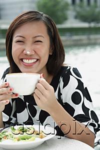 AsiaPix - Young woman with cappuccino cup, foam on her nose
