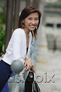 AsiaPix - Woman leaning on railing, smiling at camera