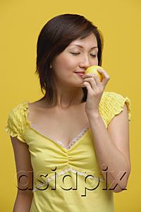 AsiaPix - Young woman smelling lemon