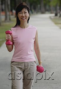 AsiaPix - Mature woman using dumbbells in park