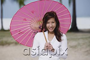 AsiaPix - Young woman using pink umbrella
