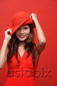 AsiaPix - Woman in red dress with red hat against red background