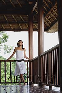 AsiaPix - Young woman in white dress standing in balcony, looking away