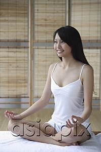 AsiaPix - Young woman sitting in yoga position