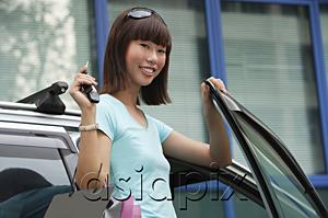 AsiaPix - Young woman getting into car, smiling at camera
