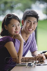 AsiaPix - Couple sitting at cafe, smiling at camera