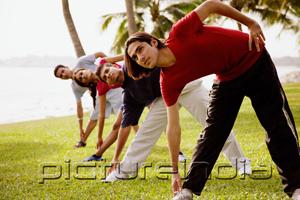 PictureIndia - Young adults doing stretching exercises