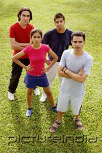 PictureIndia - Young adults standing, looking up at camera
