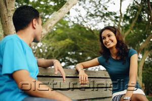 PictureIndia - Couple sitting on park bench, talking
