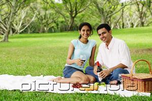 PictureIndia - Couple having a picnic, looking at camera, portrait