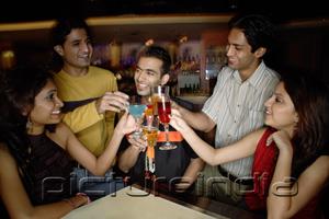 PictureIndia - Young adults toasting drinks in club