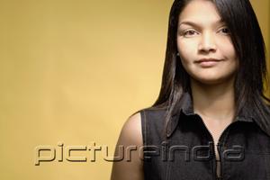 PictureIndia - Young woman against yellow background