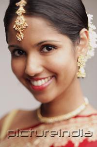 PictureIndia - Woman in wearing Indian jewellery, smiling at camera