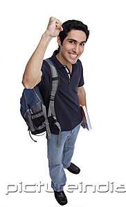 PictureIndia - College student looking at camera, raising a fist, smiling