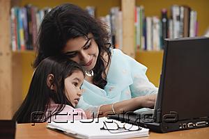 PictureIndia - Woman and girl looking at laptop